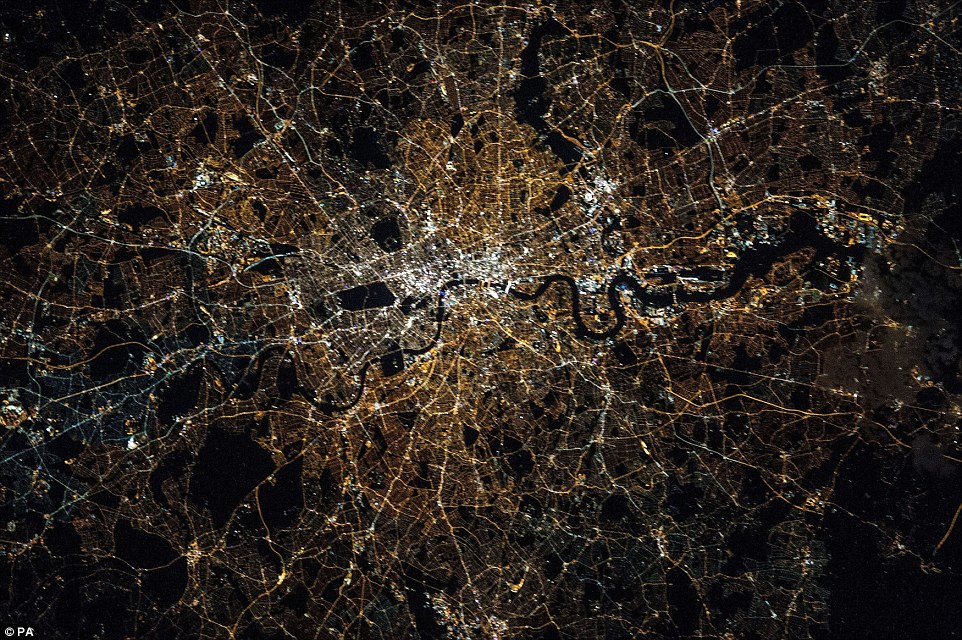 Thames winding its way through the centre of the city with the brightest lights concentrated around the Square Mile