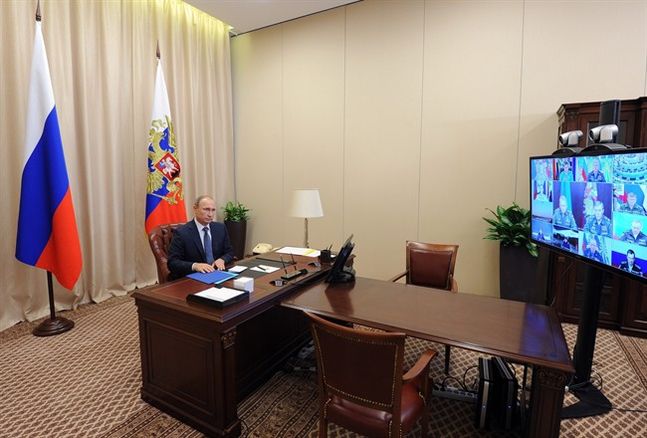 Russian President Vladimir Putin holds a video conference with the top military brass on a Russian air campaign in Syria in the Novo Ogaryovo residence outside Moscow Russia Friday Nov. 20 2015. Russian long-range bombers and navy ships have launched