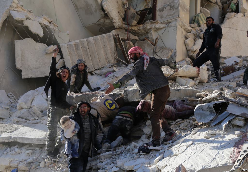 Civilians and rescue workers remove a toddler and search for other victims amid the rubble of a building following a reported air strike by Syrian government forces on the Sukkari neighborhood of Syria's northern city of Aleppo