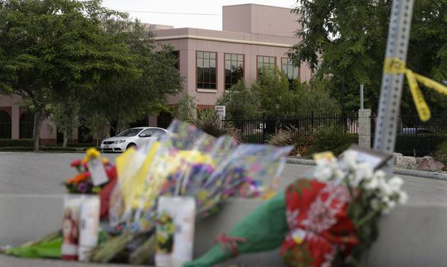 Flowers are placed near the building top center where Wednesday's shooting rampage took place at the Inland Regional Center Sunday Dec. 6 2015 in San Bernardino Calif. The FBI said it's investigating the massacre in San Bernardino Califo