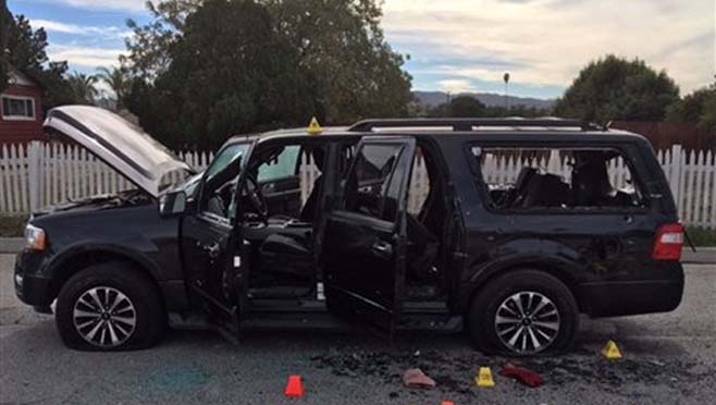 San Bernardino County Sheriff's Department shows a vehicle at the scene of a shootout in San Bernardino Calif. Multiple attackers opened fire on a banquet at a social services center for the disabled in San Bernardino on W