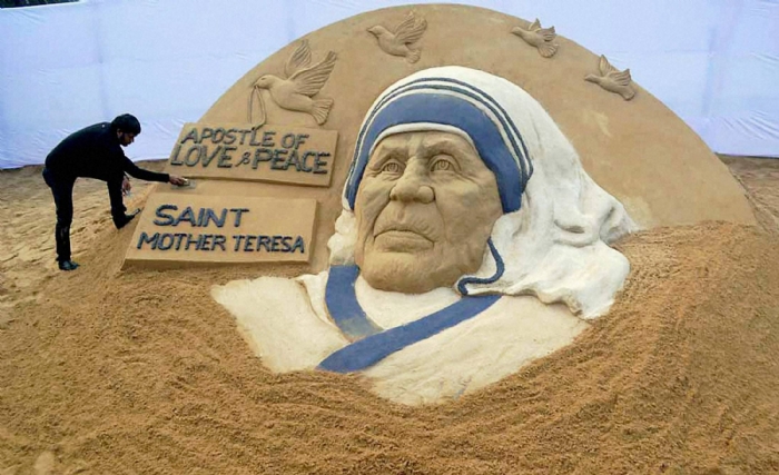 Sand artist Sudarsan Pattnaik creates a sand sculpture of Mother Teresa at Rourkela Steel City in Sundargarh district on Friday