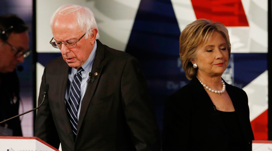 Democratic U.S. presidential candidate former Secretary of State Hillary Clinton walks past fellow candidate and Senator Bernie Sanders