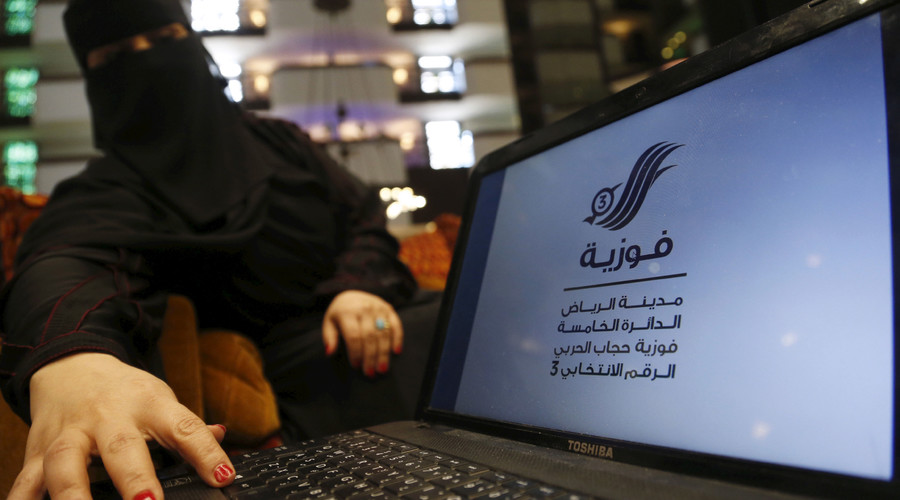 Saudi woman Fawzia al-Harbi a candidate for local municipal council elections shows her candidate biography at a shopping mall in Riyadh