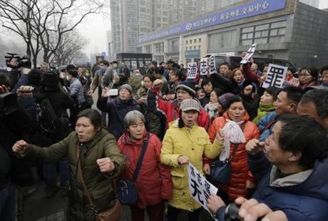 Supporters of prominent rights lawyer Pu Zhiqiang chanted slogans as they gathered near the Beijing Second Intermediate People's Court Monday