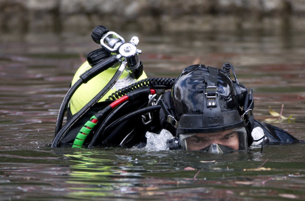 An FBI diver searches Seccombe Lake Friday following leads that Syed Rizwan Farook and Tashfeen Malik visited the area prior to their rampage