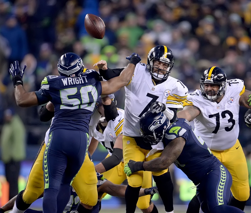 20151129pdSteelersSports12 Ben Roethlisberger is pressured Sunday by Seattle's K.J. Wright late in the fourth quarter at Century Link Field