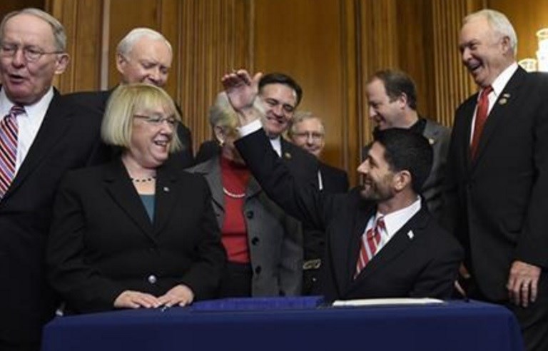 House Speaker Paul Ryan of Wis. sits down to sign legislation on Capitol Hill in Washington Wednesday Dec. 9 2015 that changes how the nation's public schools are evaluated rewriting the landmark No Child Left Behind education law of 2002. AP