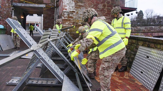 Soldiers helping to set up flood defences in Appleby as the Army was called in to support efforts to protect flood-hit areas of Cumbria