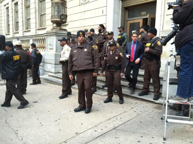 Sheriff's deputies gather outside the Courthouse East after the William Porter trial ended in a hung jury