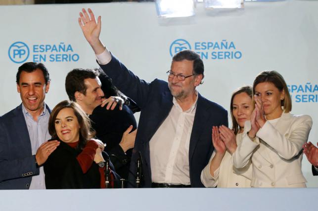 Spanish Prime Minister and Popular Party leader and candidate for the upcoming December 20 general election Mariano Rajoy waves after delivering at PP`s headquarters after the results of Spain`s general election in Madrid