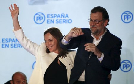 Spain's Prime Minister and People's Party candidate Mariano Rajoy gestures while addressing supporters from a balcony at the party headquarters next to his wife Elvira Fernandez after results were announced in Spain's general election in Madrid Spai