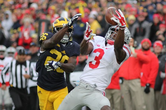 OSU redshirt junior wide receiver Michael Thomas hauls in a pass over Michigan's Jourdan Lewis during a game on Nov. 28 at Michigan Stadium. Credit Samantha Hollingshead