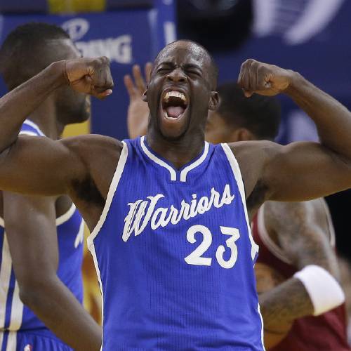 Warriors&#039 Draymond Green celebrates after scoring against the Cleveland Cavaliers during the first half of an NBA basketball game Friday Dec. 25 2015 in Oakland Calif