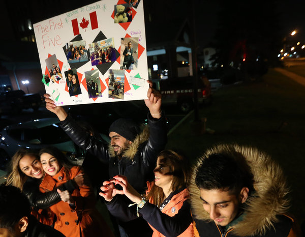 Steve Russell via Getty Images
Chaim Ifrah and Shai Reef Jewish Torontonians wait at terminal one for refugees with a'Welcome to Canada sign