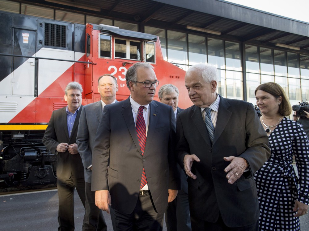 Minister of Immigration Refugees and Citizenship John Mc Callum speaks with Chairman of the board of directors of CN Robert Pace after CN announced it was donating $5 million to help house refugees