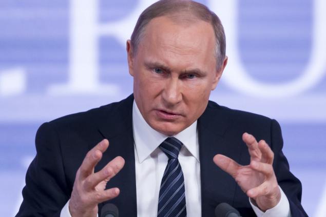 Russian President Vladimir Putin gestures during his annual end of year news conference in Moscow during which he offered high praise for Donald Trump