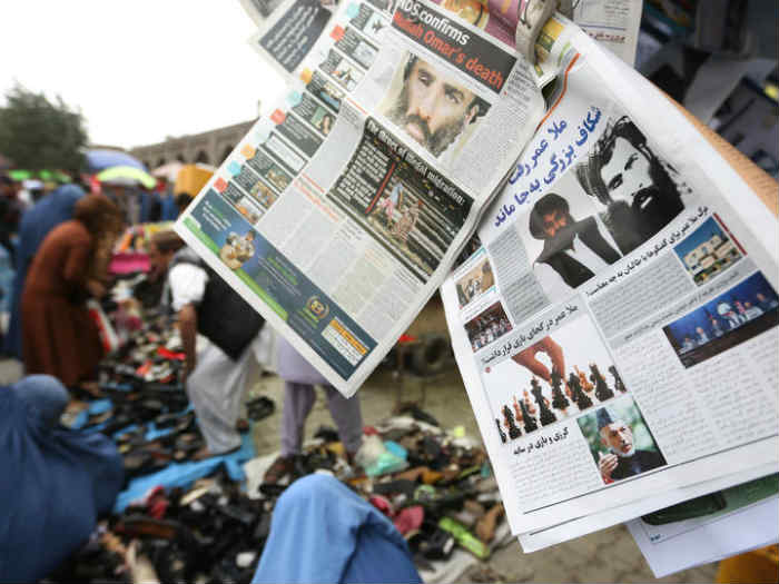 Newspapers hang for sale at a stand carrying headlines about the new leader of the Afghan Taliban Mullah Akhtar Mohammad Mansoor in Kabul Afghanistan Saturday Aug. 1 2015. The new leader of the Afghan Taliban vowed to continue his group's bloody