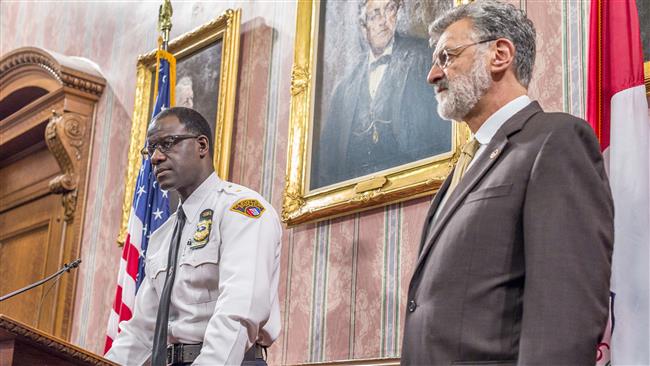 Cleveland Chief of Police Calvin Williams speaks to reporters Cleveland Mayor Frank Jackson listens in Cleveland City Hall