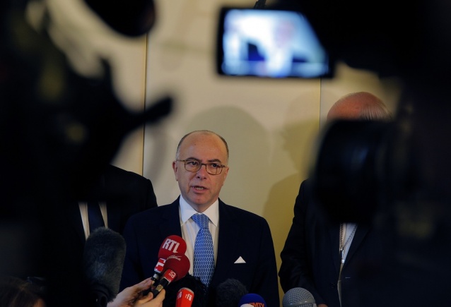 French Interior Minister Bernard Cazeneuve delivers his speech during a press conference with religious leaders in Paris Tuesday. France’s interior minister says the government will tighten security around churches around Christmas amid continued