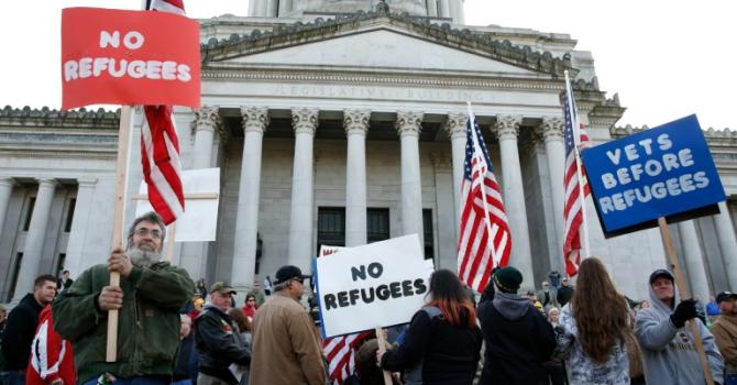 Protestors gather on the steps of the state capitol to protest Governor Jay Inslee's welcoming of refugees in Olympia Washington