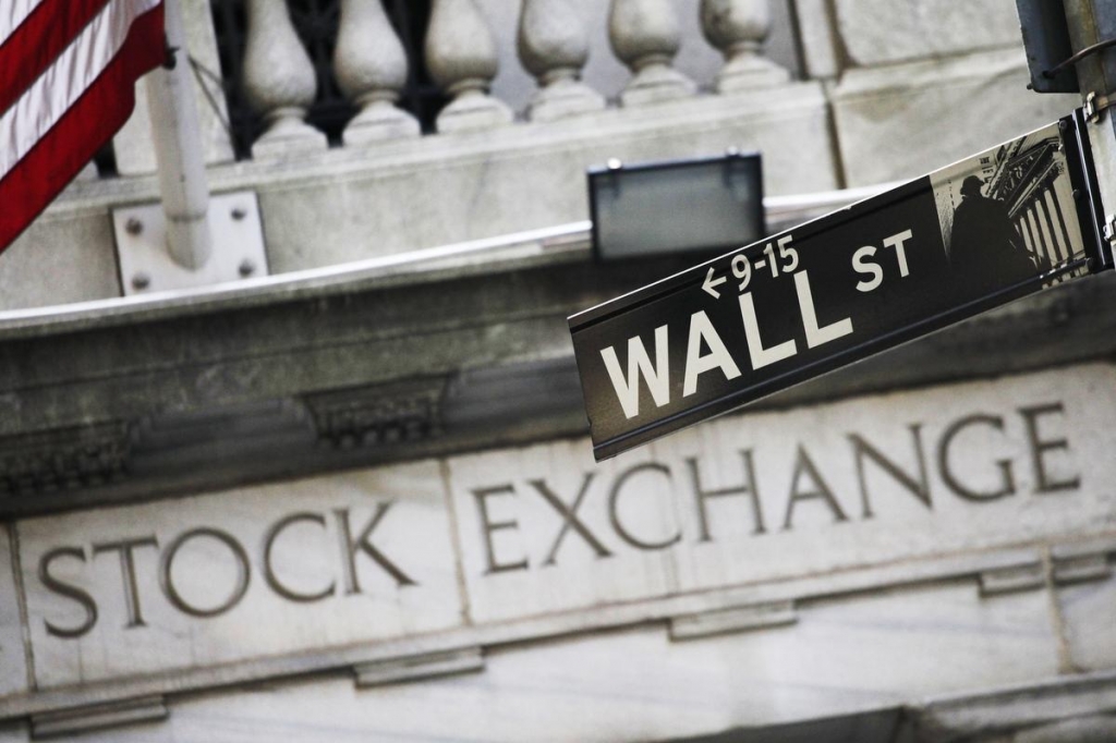 The Dow rose 122 points on Monday. Crude oil prices fell 1 percent.  MARK LENNIHAN AP