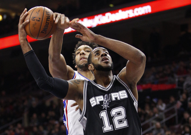 San Antonio Spurs La Marcus Aldridge right goes up for the shot as Philadelphia 76ers Jahlil Okafor left reaches from behind and will draw the foul during the first half of an NBA basketball game Monday Dec. 7 2015 in Philadelphia. (AP