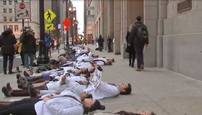 The students laid in silence for 16 minutes – representing the number of times Laquan Mc Donald was shot