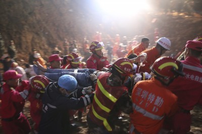 The 19-year-old survivor is carried on a stretcher after being pulled out by rescuers more than 60 hours after Sunday’s landslide