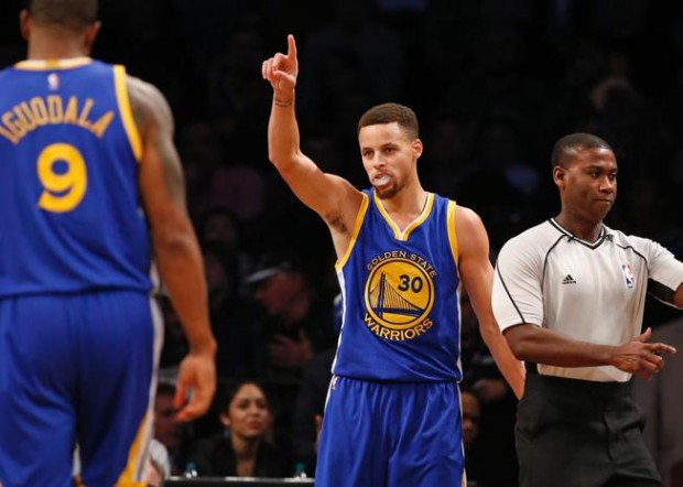 Golden State Warriors guard Stephen Curry reacts after scoring in the second half of an NBA basketball game against the Brooklyn Nets Sunday Dec. 6 2015 in New York. Curry had 28 points as the Warriors defeated the Nets 114-98. AP