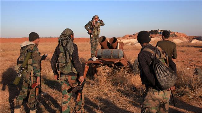 A group of Syrian forces inspect a home-made rocket launcher during a military operation against Takfiri Daesh terrorists