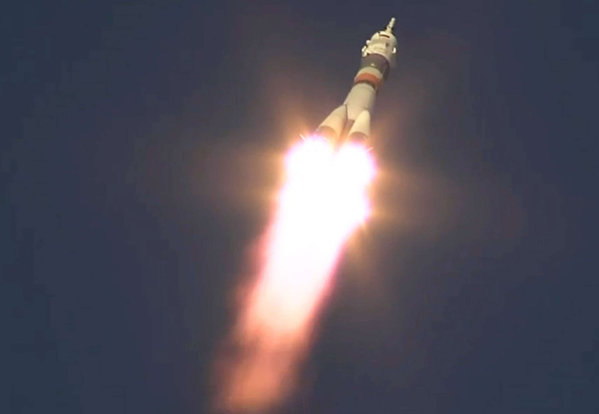 The spacecraft carrying a Russian American and Briton lifts off from the Kazakhstan launch site