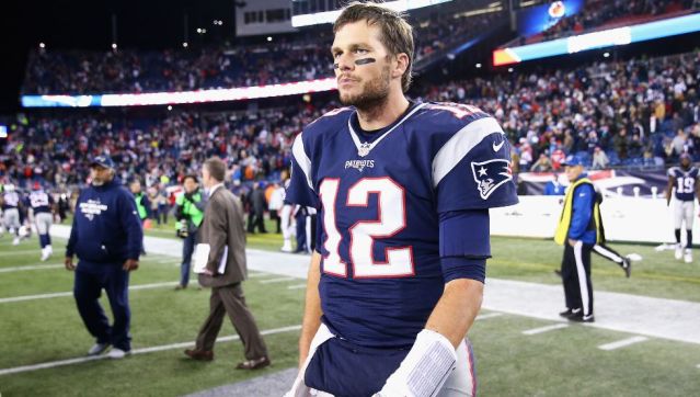 Tom Brady walks off the field at Gillette Stadium dejected Sunday night