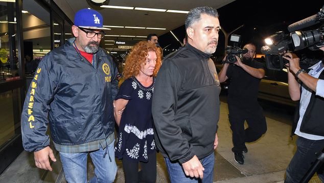 Tonya Couch center is taken by authorities to a waiting car after arriving at Los Angeles International Airport Thursday Dec. 31 2015 in Los Angeles. A