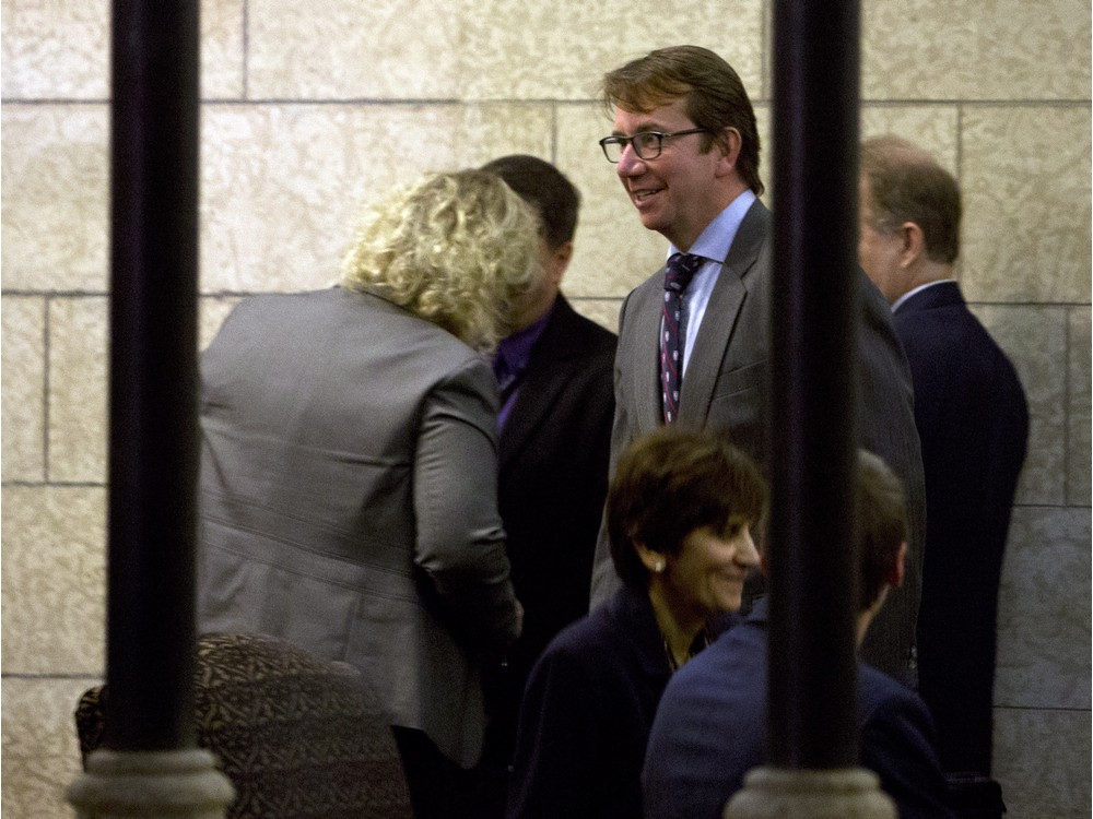 Treasury Board President Scott Brison centre makes his way to a meeting of cabinet on Parliament Hill Thursday