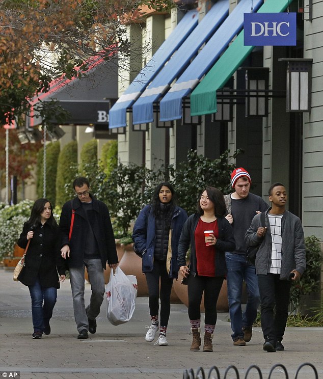 Shoppers walk through an outdoor mall on Thursday in Alameda California. A recent poll has found around 17 per cent of Americans had not started holiday shopping about a week before Christmas