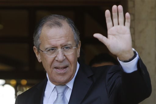 Russian Foreign Minister Sergey Lavrov as he waves to the media after he arrives at the presidential palace for talks with Cyprus President Nicos Anastasiades in Nicosia Wednesday Dec. 2 2015