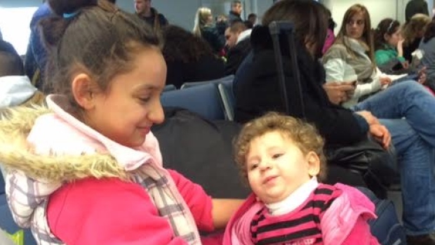 Two sisters await their first flight as a Canadian military aircraft is set to transport 160 Syrian refugees to Canada today