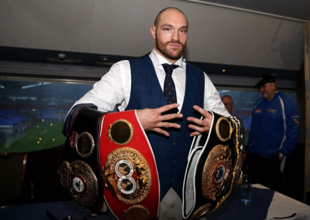 Tyson Fury holds his belts- he has now been stipped off the IBF title