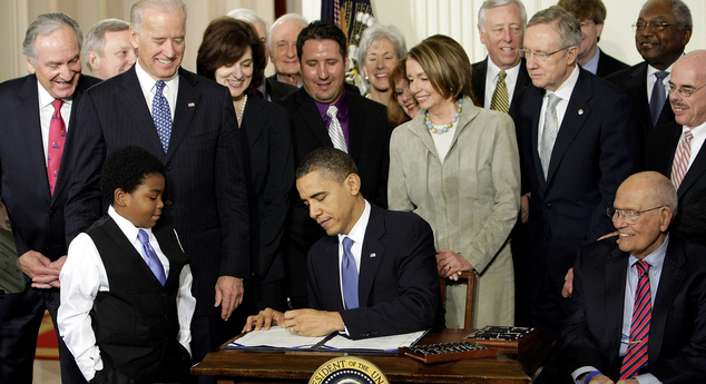 President Barack Obama signs the Affordable Care Act in the East Room of the White House in Washington. A governmen