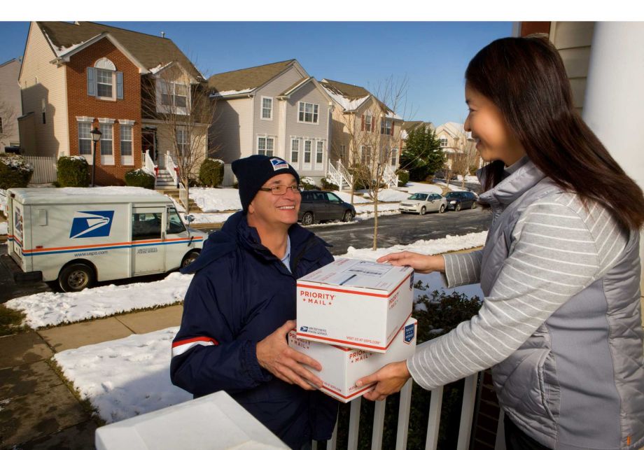 U.S. Postal Service letter carrier delivering packages during the holidays