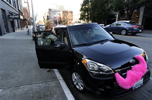 Katie Baranyuk gets out of a car driven by Dara Jenkins a driver for the ride-sharing service Lyft after getting a ride