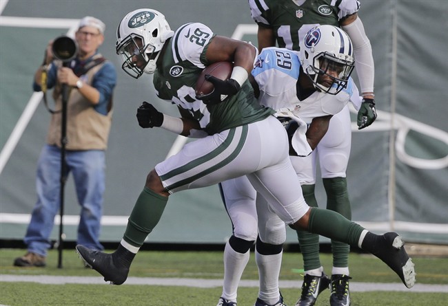 New York Jets running back Bilal Powell runs past Tennessee Titans Perrish Cox for a touchdown during the first half of an NFL football game Sunday Dec. 13 2015 in East Rutherford N.J