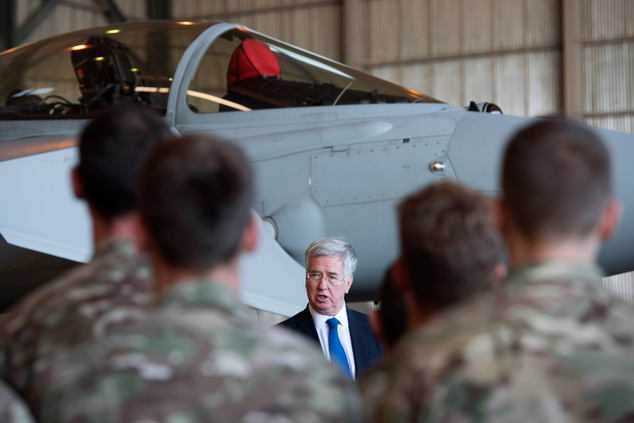 British Defence Minister Michael Fallon talks to British pilots and soldiers at RAF Akrotiri a British air base near the coastal city of Limassol Cyprus