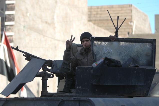 A member of Iraq's counter-terrorism forces flashes the V sign for victory in the al Tameem district of Ramadi Iraq on Wednesday. Iraqi forces were able to retake a large part of the city