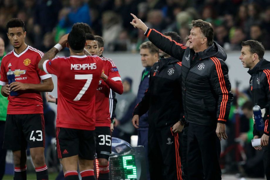 Manchester United's manager Louis van Gaal 2nd from right gestures to players during the Champions League group B soccer match between VfL Wolfsburg and Manchester United in Wolfsburg Germany Tuesday Dec. 8 2015