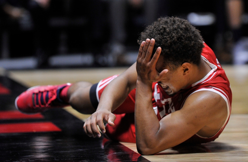 SALT LAKE CITY UT- DECEMBER 2 Brandon Taylor #11 of the Utah Utes lays on the floor after being fouled in the second half by Nick Emery #4 of the Brigham Young Cougars at the Jon M. Huntsman Center