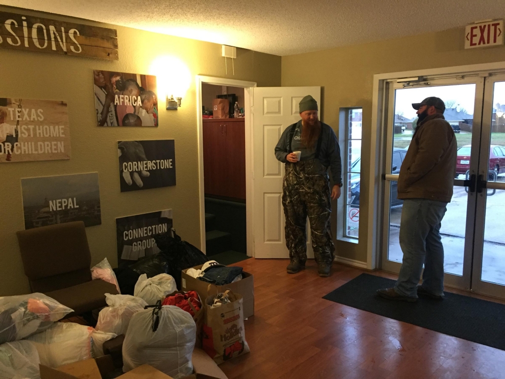 Rowlett residents Kyle Gramling and Brett Clickner stand next to donated goods to be sorted by volunteers at Connection Community Church on Sunday