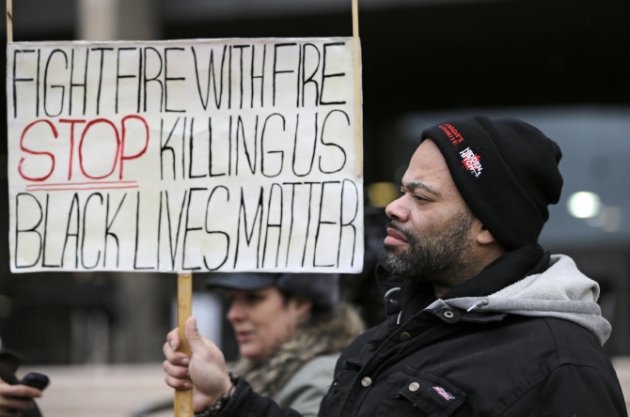 Corky Warren protests outside the Cuyahoga County Justice Center Tuesday Dec. 29 2015 in Cleveland
