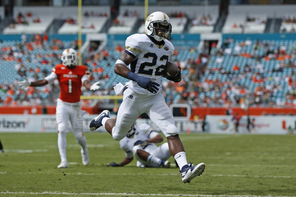 MIAMI GARDENS FL- NOVEMBER 21 Broderick Snoddy #22 of the Georgia Tech Yellow Jackets scores a first quarter touchdown against the Miami Hurricanes